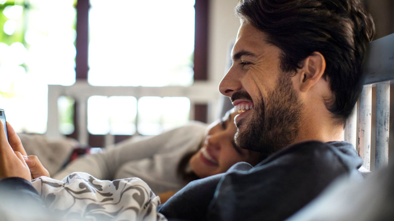 A couple is smiling in the sofa with coffee; image used for HSBC Australia Accounts page.