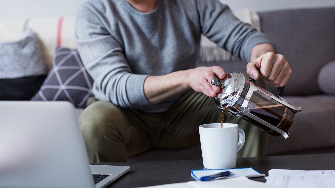 A man pouring coffee at home; image used for HSBC Property Investment page.