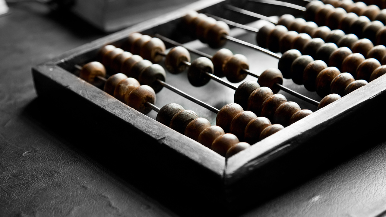 An abacus on a table; image used for HSBC Saving Accounts Comparison.