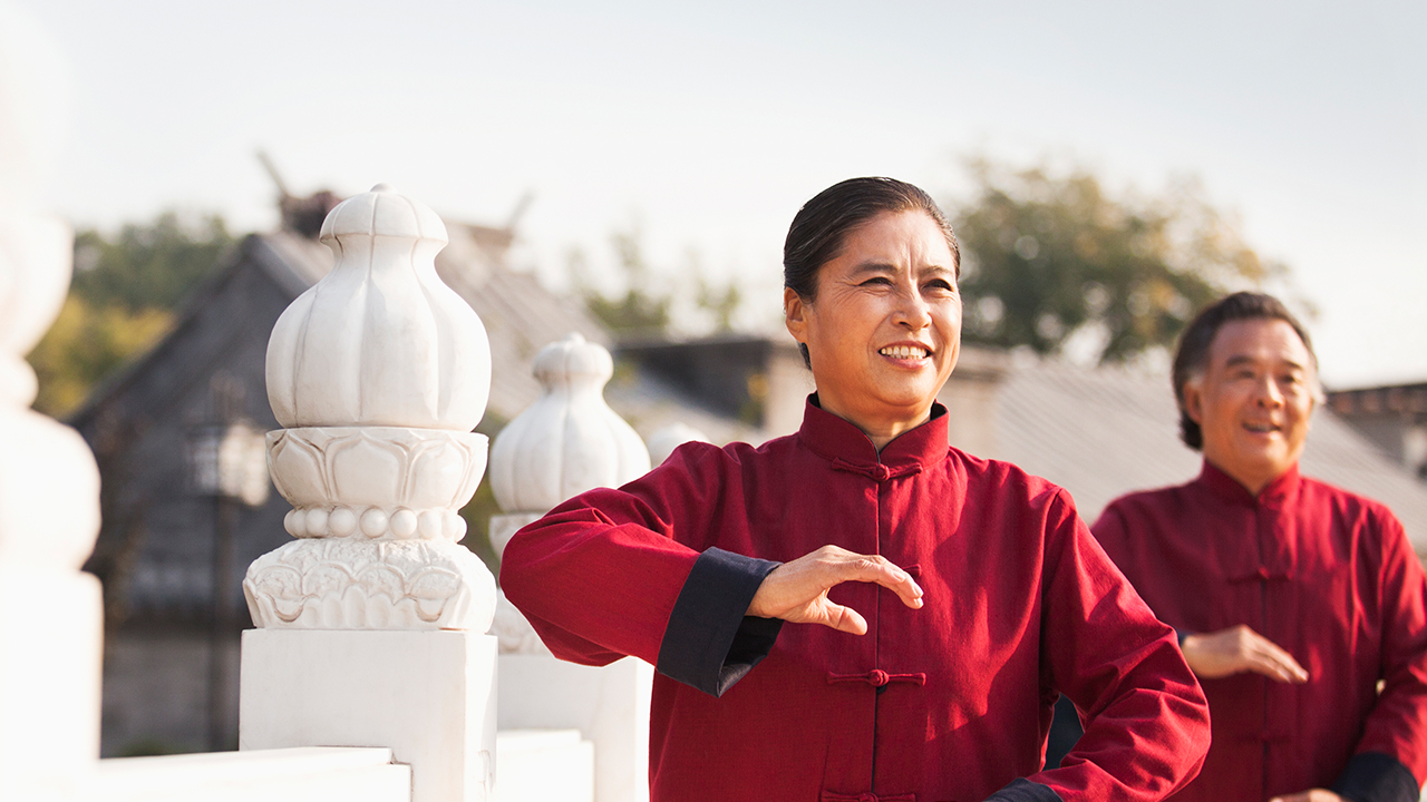 Asian couple doing Tai Chi at a temple; image used for HSBC Foreign Currency Term Deposit page.