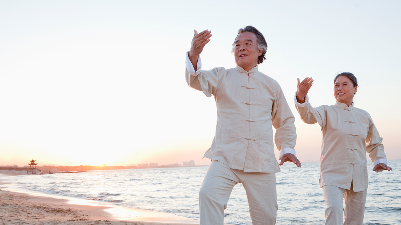 Asian couple doing Tai Chi on beach; image used for HSBC Term Deposit Accounts page.
