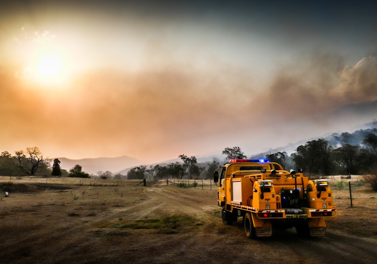 Rescue truck driving through dry bushland; image used for HSBC Australia bushfire support.