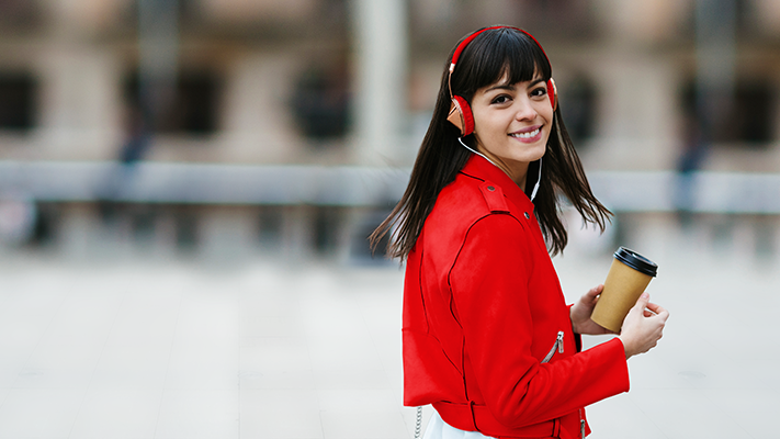 A smiling girl is holding a coffee cup; image used for HSBC Every Global Account.
