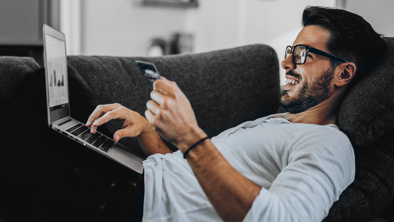 A man using laptop on a sofa; image used for HSBC Australia