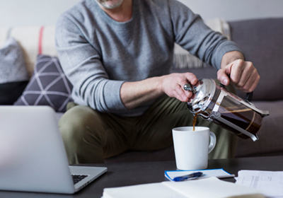 A man pouring coffee at home; image used for HSBC Property Investment page.