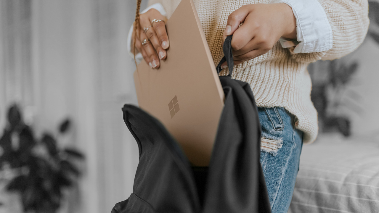 A person putting a laptop inside a backpack; image used for HSBC Australia Security.