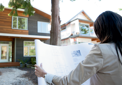 A woman looking at plans; image used for HSBC Buying and Selling Your Home page.