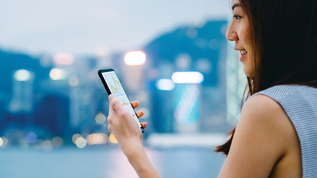 Woman using phone; image used for HSBC Australia Investments.