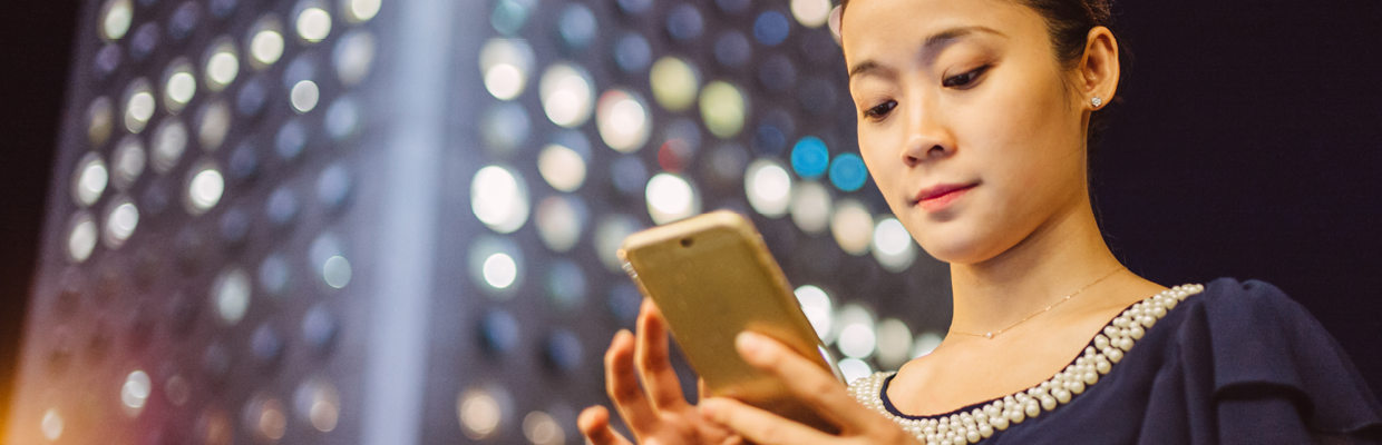 A woman checking on phone; image used for HSBC Australia global view and global transfer.