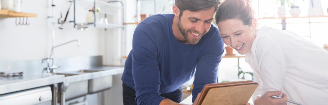 Couple looking at iPad; image used for HSBC Cost of buying a house page. 