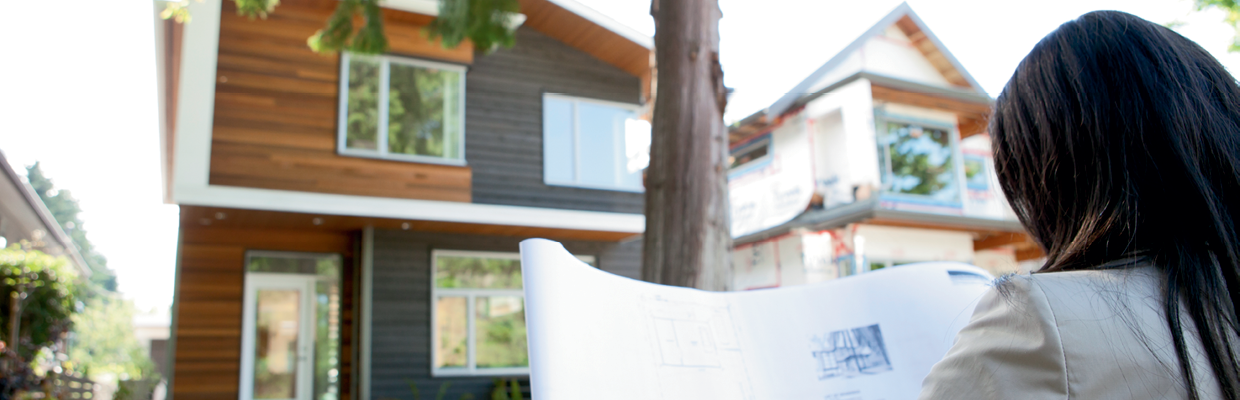  A woman looking at plans; image used for HSBC buying and selling your home page. 