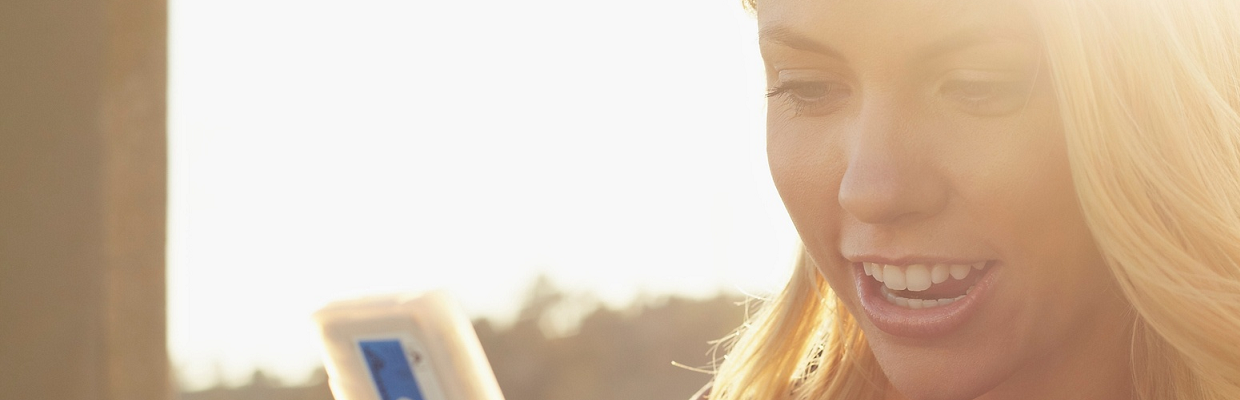 A woman looking at phone; image used for HSBC Australia Manage your credit card. 