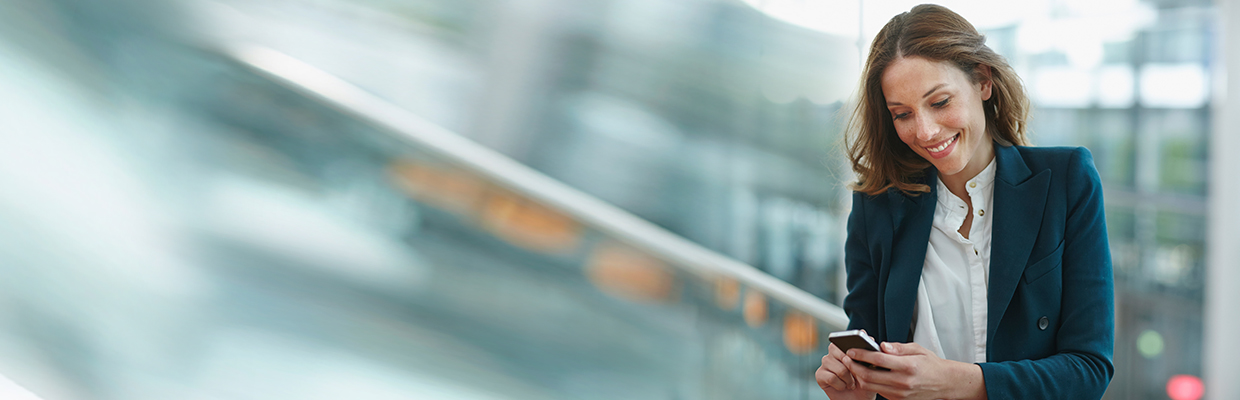 A young business woman using smartphone outdoor; image used for HSBC What is a joint account.