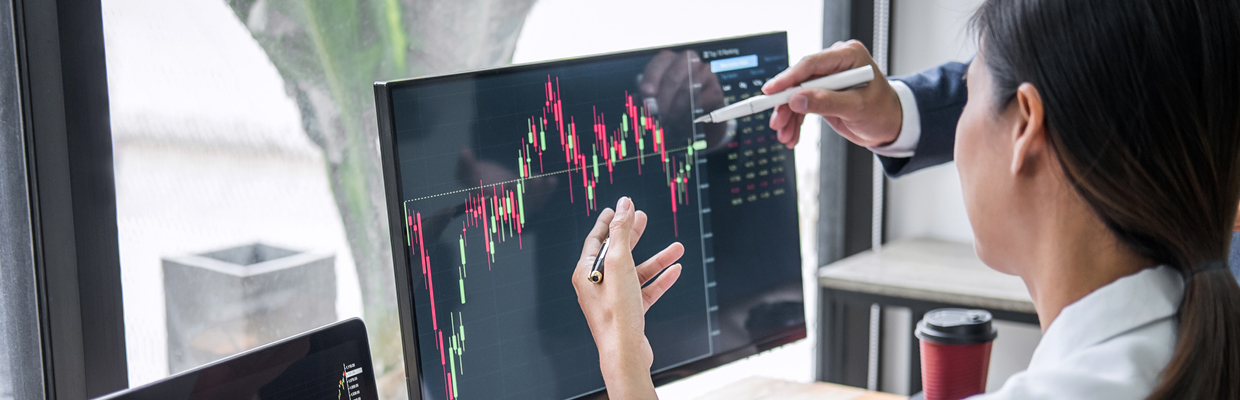 Two people analyzing stock trends with laptop; image used for HSBC Australia investment research and insights.