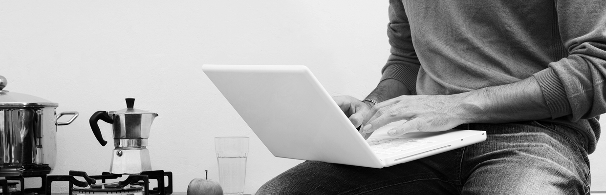 A man using laptop at home; image used for HSBC Australia Contact us page.