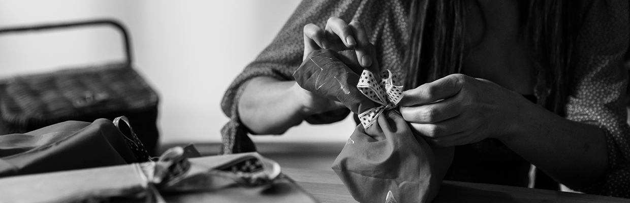 A person opening a gift; image used for HSBC Australia Rewards.