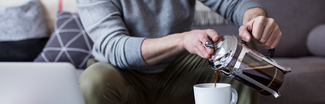 A man pouring coffee at home; image used for HSBC Property Investment page.