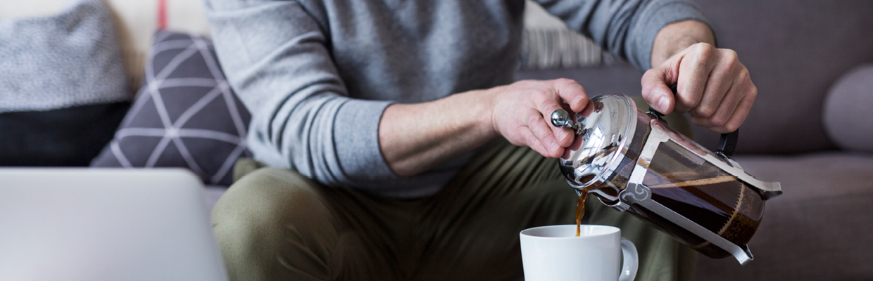 A man pouring coffee at home; image used for HSBC Property Investment Details page.