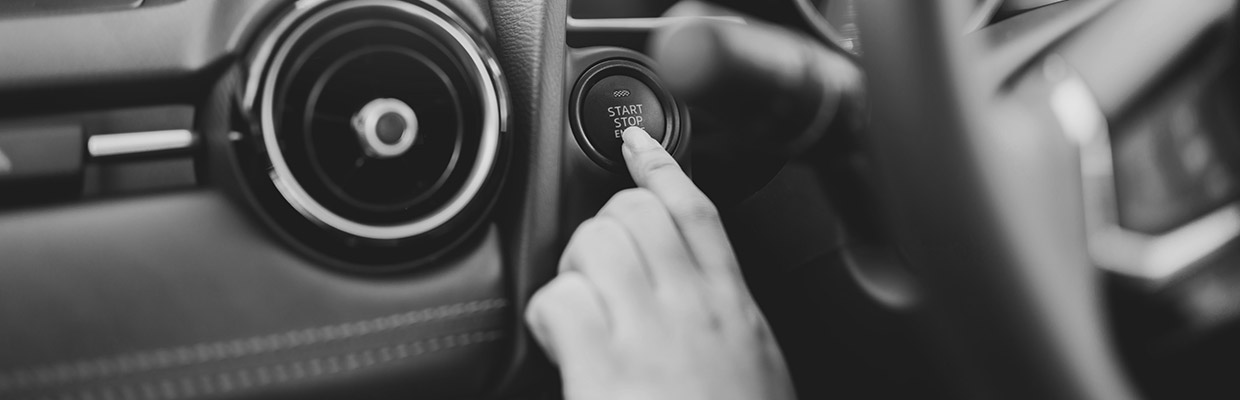 Pushing an engine start button of a car; image used for HSBC Australia car loan page.