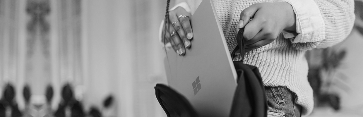 A person putting a laptop inside a backpack; image used for HSBC Australia Security.