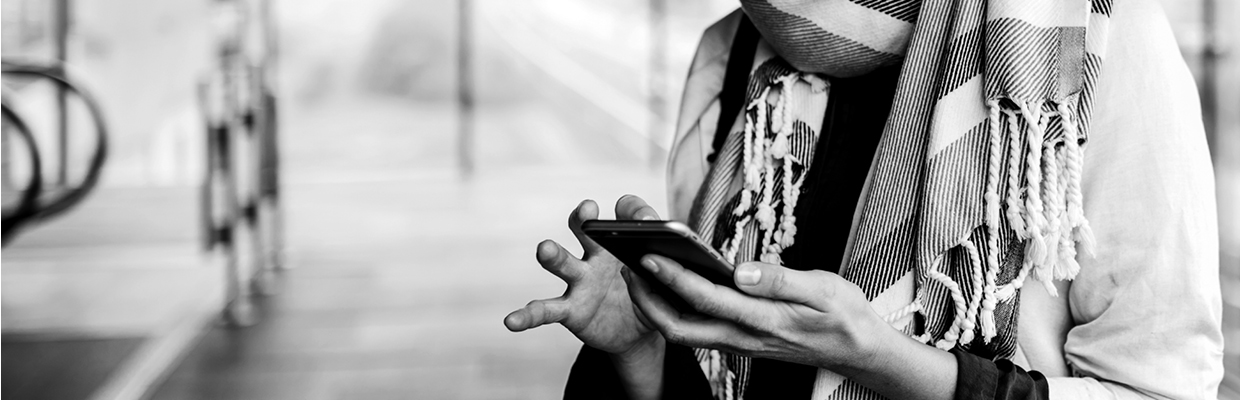 A person typing on the mobile phone; image used for HSBC Australia report a lost and stolen card.