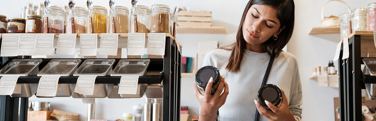 A person using tablet and holding a coffee mug on hand; image used for HSBC Compare Foreign Currency Accounts page.