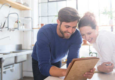Couple looking at iPad; image used for frequently asked questions.