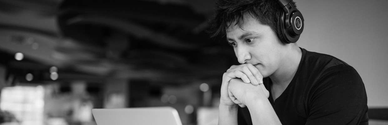 A man working on laptop with wearing headphones; image used for HSBC Australia Using a personal loan to fund your MBA.