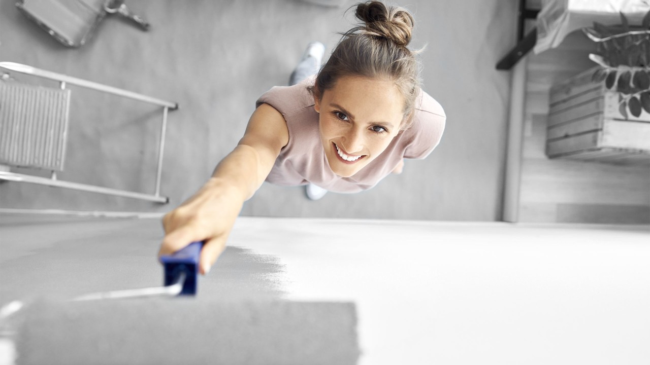 A woman painting house; image used for HSBC Australia Ways you can use a personal loan.