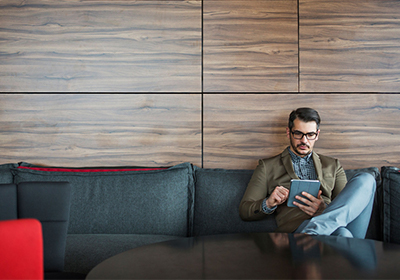 Man using iPad; image used for financial rewards.