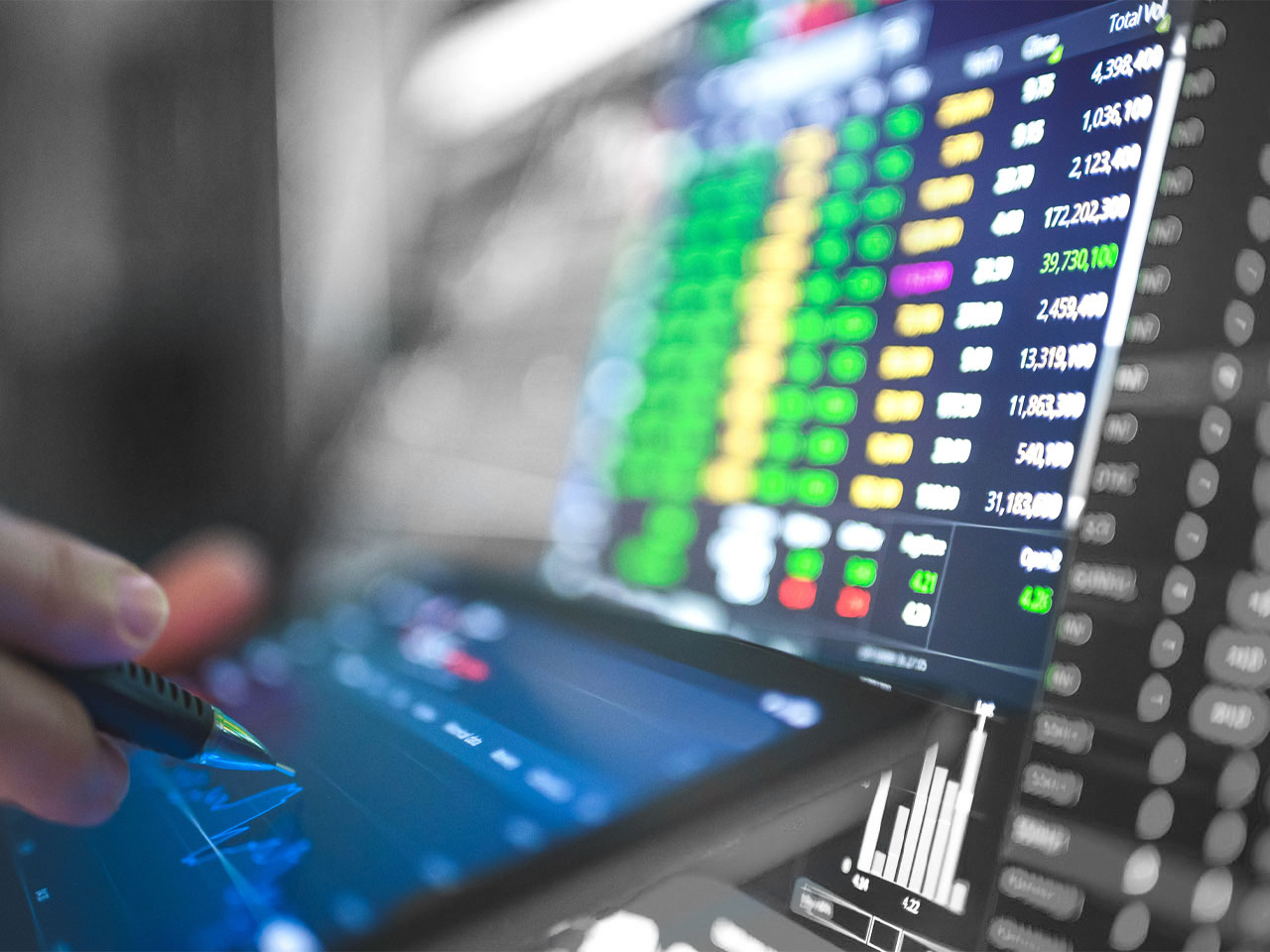 Looking at the stock market with digital devices.